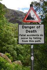 Sign post at Steall Gorge at the foot of Ben Nevis mountain on trail to Steall Waterfall showing danger of death from fatal falls Scotland UK