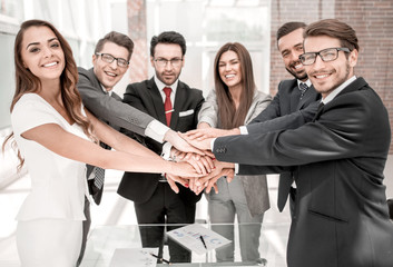 happy business team joining hands together
