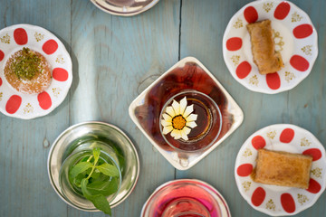 traditional Turkish red black tea tulip glass green flowers sweet dessert afternoon tea break