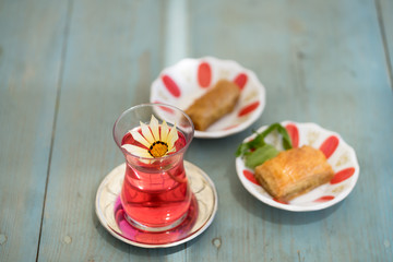 traditional Turkish red black tea tulip glass green flowers sweet dessert afternoon tea break