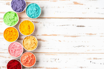 Top view of colorful rainbow ice cream in cups. Copy space