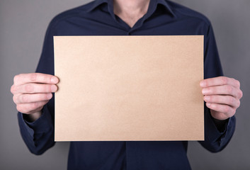 A man holding blank letterhead