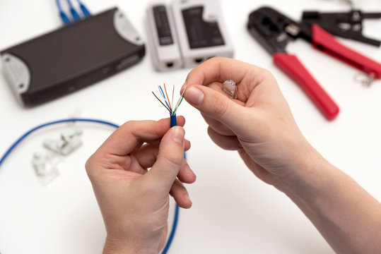 Technician holding twisted pair internet cable