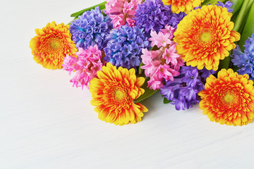 Colorful bouquet of yellow gerberas and hyacinths on white background. Copy space. Greeting card.