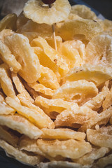Dehydrated pineapple candy being sold in the shop window or in the fair of artesian vegan products made by hand