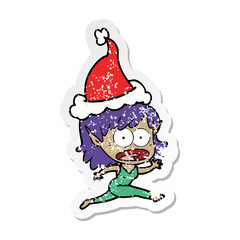 distressed sticker cartoon of a shocked elf girl wearing santa hat