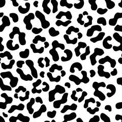 Fototapeta na wymiar The seamless pattern of large black and white spots imitates the skin of a leopard