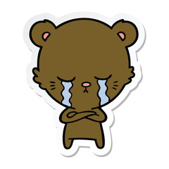 sticker of a crying cartoon bear