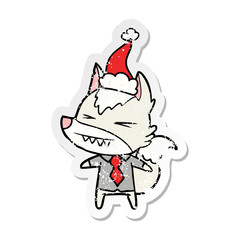 angry wolf boss distressed sticker cartoon of a wearing santa hat