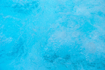 Fototapeta na wymiar A natural texture .Turquose water in the pool of an Italian resort