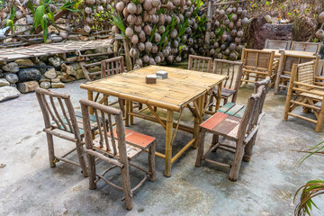 Fototapeta na wymiar Wooden table and chairs in empty beach cafe next to sea. Island Koh Phangan, Thailand