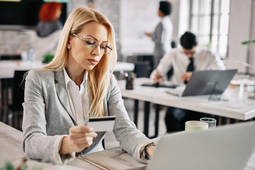 Businesswoman e-banking while working in the office.