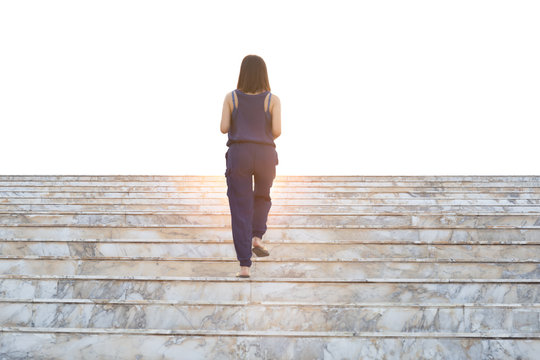 Rear View Of Woman Walking Up The Stairs Isolated In White Background.