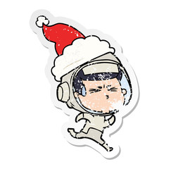 distressed sticker cartoon of a stressed astronaut wearing santa hat