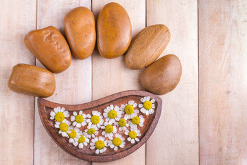 chamomile flowers and brown stones