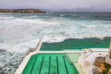 Fototapeta na wymiar Sydney Bondi beach swimming pool. Australia travel. Ocean waves over famous popular tourist attraction on the coast.