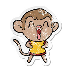 distressed sticker of a cartoon laughing monkey