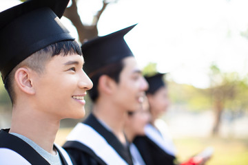 smiling asian young man at graduation