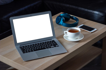 Laptop and a cup of tea on the wooden table