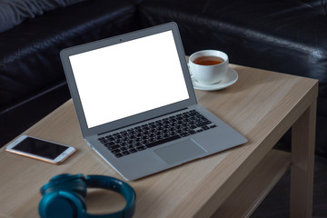 Workplace of a man with laptop and a cup of tea