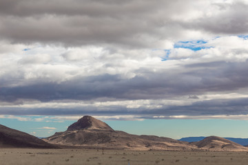 Fototapeta na wymiar Filtered light through clouds on New Mexico mountain landscape, horizontal aspect