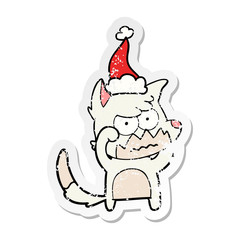 distressed sticker cartoon of a annoyed fox wearing santa hat