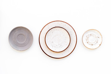 Ceramic plates pattern on white background top view copy space