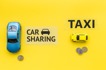 Carsharing vs taxi concept. Comparing carsharing system and taxi. Ship trip concept. Toy cars ans...