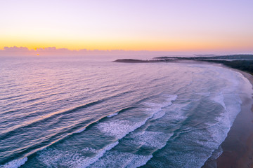 Aerial landscape of sunrise over ocean coastline near Arrawarra, New South Wales, Australia