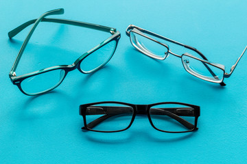 Accessories for eyes. Glasses with transparent lenses and different frames on blue background