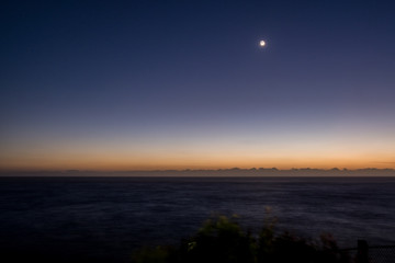moon and dawn horizon at the beach