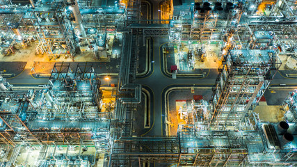 Oil refinery plant form industry zone, Aerial view oil and gas industrial, Refinery factory oil storage tank and pipeline steel at night.