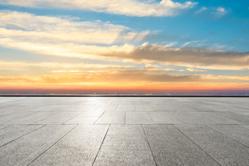 Empty square floor and modern city skyline with beautiful colorful clouds at sunset
