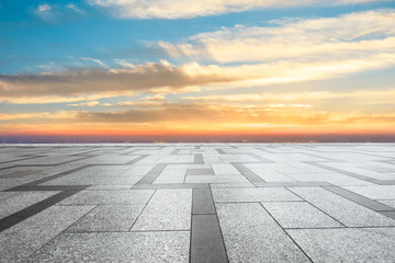 Empty square floor and modern city skyline with beautiful colorful clouds at sunset