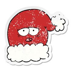 distressed sticker of a cartoon christmas santa hat with tired face