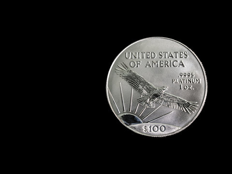 1oz Platinum coin on black with copy space.