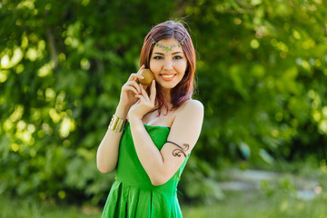Fototapeta premium Beautiful young asian woman with fresh kiwi