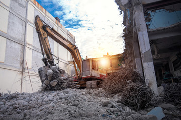 Fototapeta na wymiar Large Construction Machinery breaking old buildings.