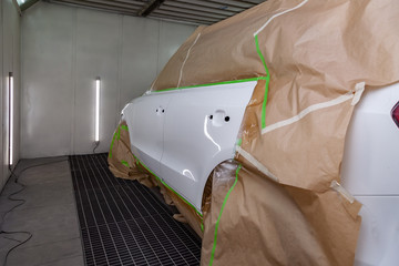 The car rear view after the accident in the camera for car body repair is partially covered with...