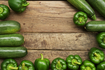 Cucumbers and sweet pepper on wooden table for background