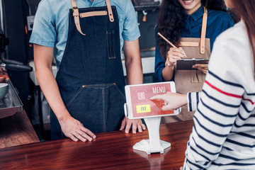 customer self service order drink menu with tablet screen at cafe counter bar,seller coffee shop...