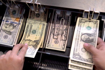 High angle view of cashier searching for change in cash