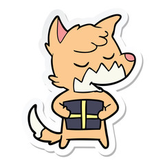 sticker of a friendly cartoon fox with christmas present