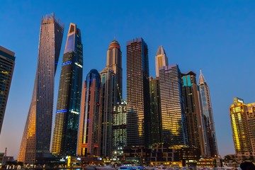 Fototapeta na wymiar Dubai, UAE - November 29, 2018: High-rise houses of modern futuristic design of Dubai Marina district.