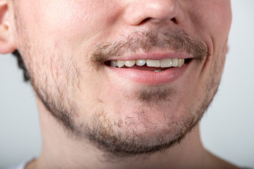 Handsome man with stubble or beard on face close up