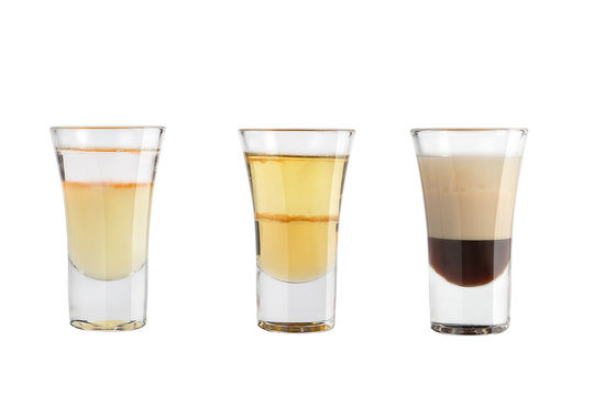 Set of alcohol shots on a white background. Three shots of a variety of alcoholic.