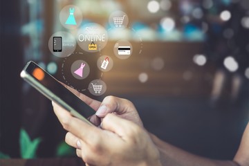 Women hand using smartphone do online selling for people shopping online with chat box, cart, dollar icons pop up. Social media maketing concept.