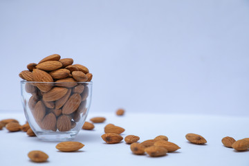 almonds on glass with white background, Indian almonds in white background