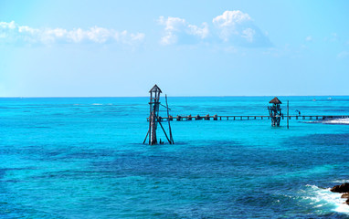 gazebo and wood tower inside colorful Caribbean sea