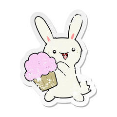 distressed sticker of a cute cartoon rabbit with muffin